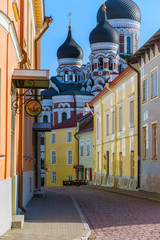Obraz premium Tallinn, Estonia - ‎25 ‎April ‎2020. Alexander Nevsky Church on the side of a small, colorful street in the old city. Medieval architecture of the country. Colorful buildings.