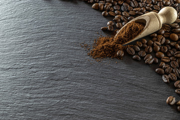 Dark coffee beans on black caffeine breakfast background. For cup of espresso food or drink. Morning energy concept and cheerfulness or evening refreshment. Macro photography, soft focus