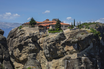 Fototapeta na wymiar Monastery, located on rocky abyss top at height of more than 400 meters. Meteora is one of largest, most important complexes of Eastern Orthodox monasteries in Greece. Meteora, Peneas Valley, Greece.