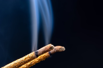 smoking flavored sticks on a black background