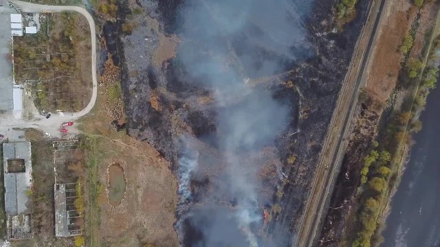 Aerial view of wildfire, spreading flames of forest fire. Natural disaster due to extreme heat and climate change