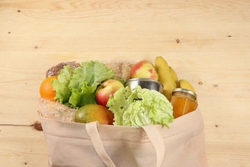 Food donations in the context of the coronovirus pandemic. Bag with the necessary products, cereals, vegetables and fruits, stew and canned goods, delivery