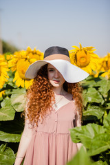 Red hair girl in sunflowers fields