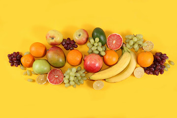 Tropical fruits, grapefruit, orange, lemon on a yellow background, healthy food, summer banner. The concept of minimal relaxation, detox diet. Place for text, flat lay.