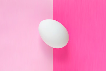 Easter egg on colorful bright pink split background