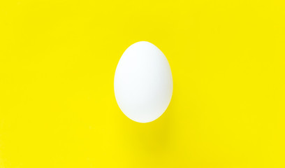 Easter egg on colorful bright yellow background