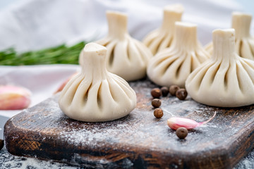Raw baozi dumplings on wooden board