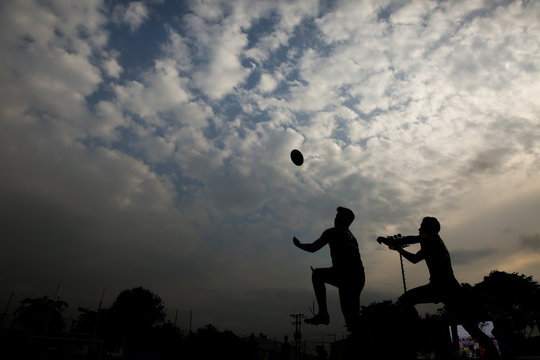 Silhouette of a man with a rugby ball