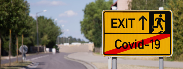 Yellow sign points away from Covid-19 to escape symbol