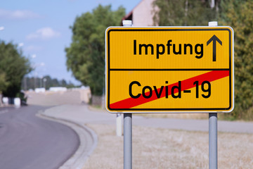 Yellow sign points away from Covid-19