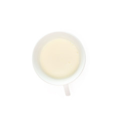 Milk in a cup isolated on white background, top view