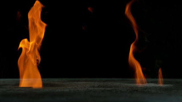 Super slow motion of empty grill grid with fire on black background. Filmed on high speed cinema camera, 1000 fps