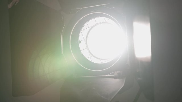 Footage of studio light being turned on and off. Floodlight flashes
