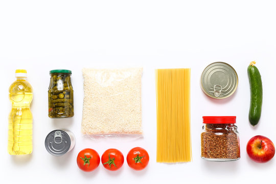 Food supplies for the period of quarantine on white background. Set of grocery items from canned food, vegetables, pasta, cereal. Food delivery concept. Donation concept. Top view.