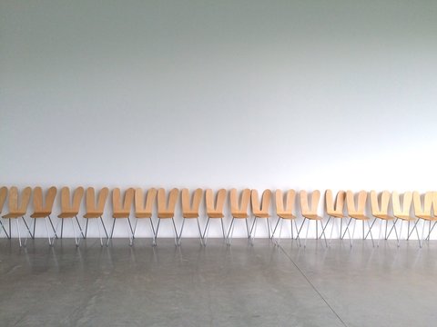 Row Of Empty Chairs Against Wall