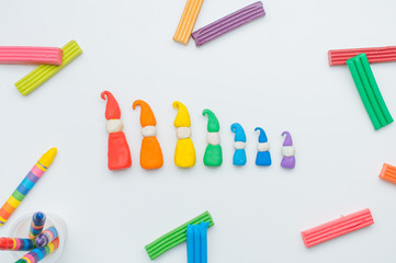 Сolorful gnomes from child's play clay on the white background