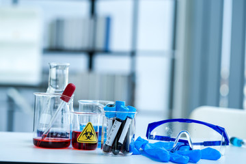 close up of blood test sample in test tube of the patient under investigation of virus infection   inside beaker in science laboratory