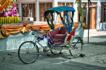 Fototapeta na wymiar Thai style vintage retro tricycle bike or rickshaw decorated and exhibited on a street market at Koh Kret island