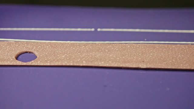 closeup panorama at purple glazed mousse cake decorated with white chocolate
