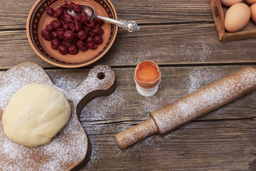 piece of cottage cheese cake and cherry berries on a glass plate and canned cherry berries, vintage toning