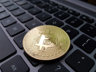 Coin crypto currency bitcoin lies on the keyboard