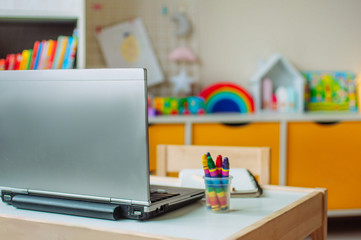 Close up of laptop on the table in the kids room using for distance online learning