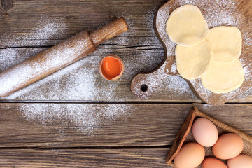 We make dough for pies on a wooden tabletop. © Roman