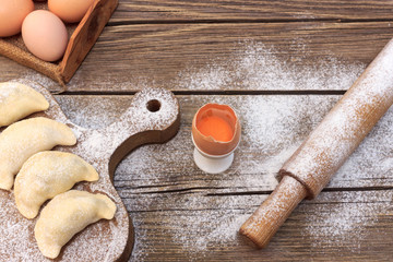 Cooking dough pies on a dough board © Roman