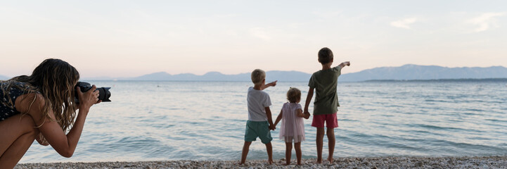 Wide view image of beautiful family moment on the beach at  dusk