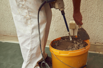 Construction worker plaster a wall.