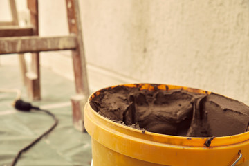 Cement in bucket for plastering. Equipment for plastering. 