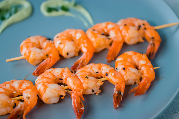 Yakitori kebabs with shrimp on a gray plate. Soft focus.