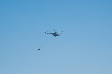 Fire helicopter extinguishes a forest fire
