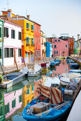 Fototapeta na wymiar Burano island. Beautiful colored houses, canal with boats. beautiful sunny day in the city