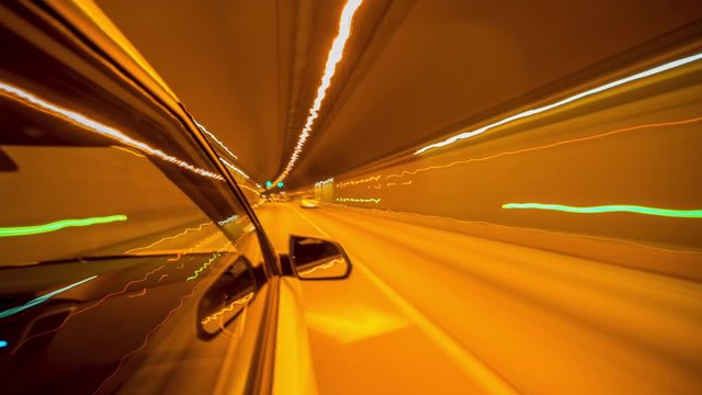 Timelapse video View from Side of Car moving in a night city, Blured road with lights with car on high speed. Concept rapid rhythm of a modern city.