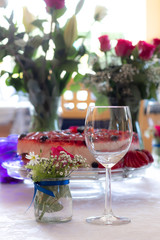 Celebration decor for wedding or birthday. Floral arraignments. Strawberry and blueberry home made cake. 