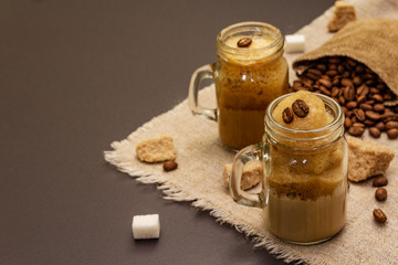 Dalgona coffee in mason jar. Korean fluffy whipped coffee beverage