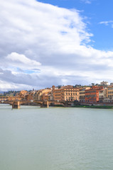 Obraz premium Cityscape of Florence, Tuscany, Italy. Historical center located along the Arno river. Blue sky and clouds over the Italian city. Vertical photo.