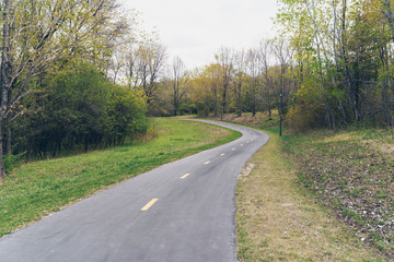 Fototapeta na wymiar Peaceful paved walking and biking trail through Elm Creek Park Reserve in Maple Grove Minnesota