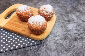 Chef decorating tasty cupcakes with cream at table