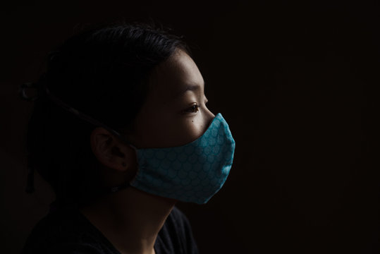 Portrait of girl wearing mask indoors