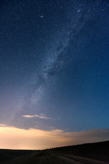 Night sky with stars and the Milky Way and meteor shower. Night landscape.