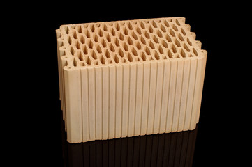 Ceramic building block isolated on the black background
