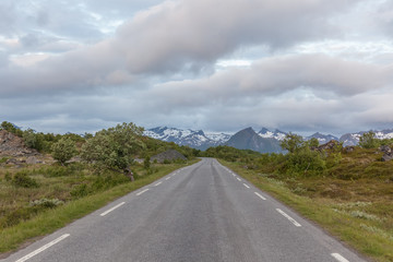 road passing in a valley between mountains in Norway, selective focus