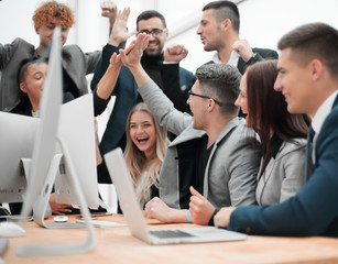 jubilant business team looking at the computer monitor