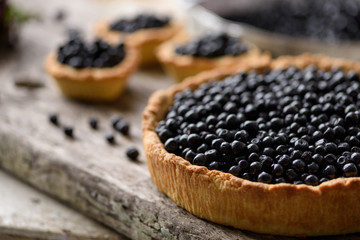 Fresh blueberry pie on an old wooden board
