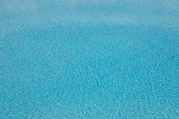 Blue and crystalline water of a swimming pool