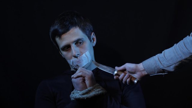 A criminal threatens a man with a knife