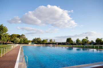 Sunny swimming pool with blue water