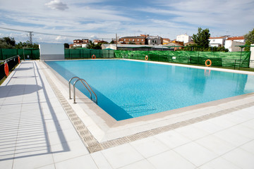 Sunny swimming pool with blue water